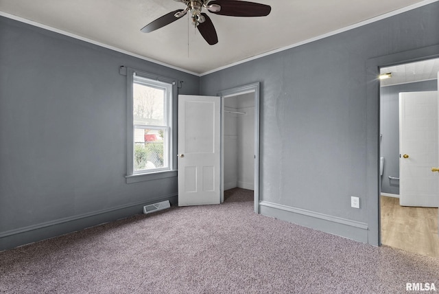706 8th St, De Witt, IA 52742 - unfurnished bedroom featuring carpet, a closet, baseboards, ornamental molding, and ceiling fan