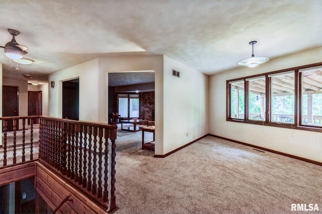 28009 230th St, Le Claire, IA 52753 - corridor with carpet, baseboards, and an upstairs landing