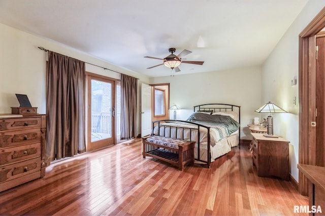 28009 230th St, Le Claire, IA 52753 - bedroom with access to outside, light wood-style flooring, and ceiling fan