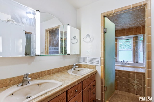 28009 230th St, Le Claire, IA 52753 - full bath with double vanity, a relaxing tiled tub, and a shower stall