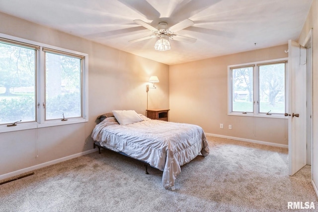 28009 230th St, Le Claire, IA 52753 - bedroom featuring carpet, baseboards, and a ceiling fan