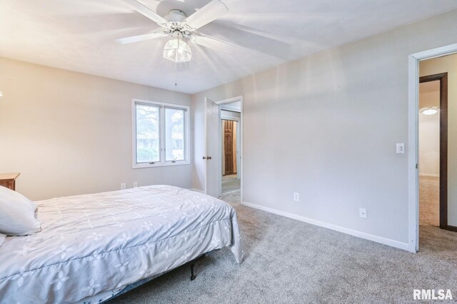 28009 230th St, Le Claire, IA 52753 - carpeted bedroom with baseboards and ceiling fan