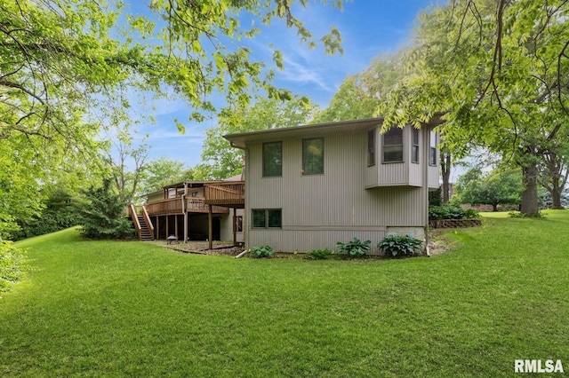 28009 230th St, Le Claire, IA 52753 - rear view of house with stairway, a deck, and a lawn