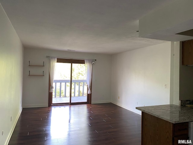 3143 4th St Unit 3143, Moline, IL 61265 - spare room featuring dark wood-type flooring and baseboards