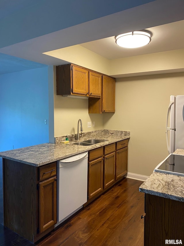 3143 4th St Unit 3143, Moline, IL 61265 - kitchen featuring white appliances, a sink, dark wood-style floors, baseboards, and brown cabinetry