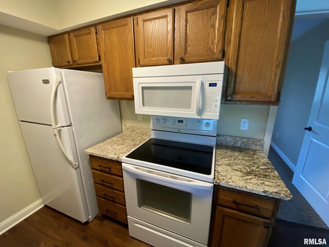 3143 4th St Unit 3143, Moline, IL 61265 - kitchen featuring white appliances, baseboards, dark wood finished floors, brown cabinetry, and light stone countertops