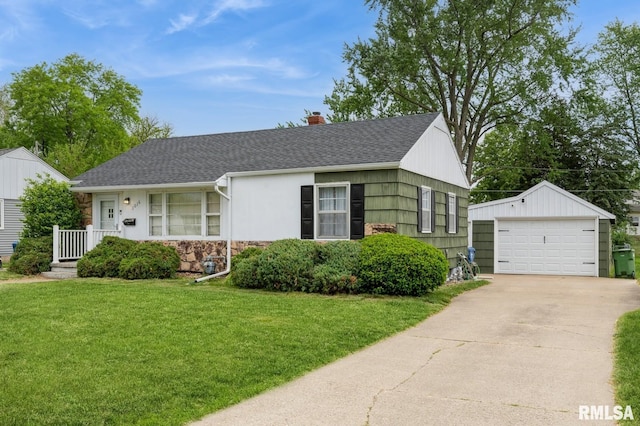 1016 13th Ave S, Clinton, IA 52732 - view of front facade with a garage, an outdoor structure, stone siding, a front lawn, and a shingled roof