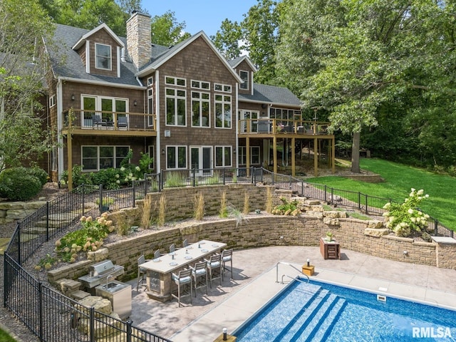 27998 229th St, Le Claire, IA 52753 - back of house featuring a patio, a chimney, a shingled roof, and outdoor dining space