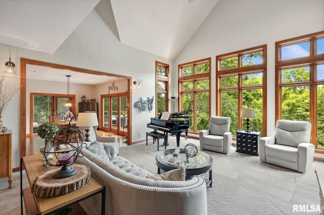 27998 229th St, Le Claire, IA 52753 - living area with high vaulted ceiling, carpet flooring, french doors, and baseboards
