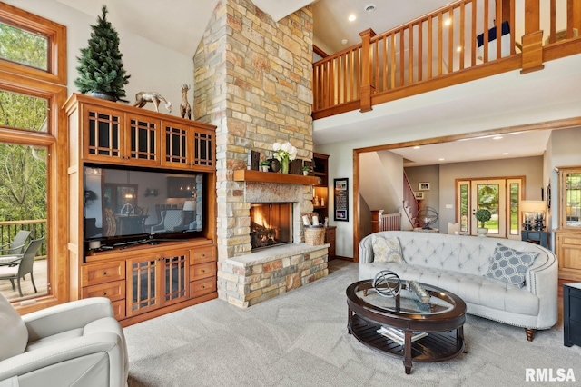 27998 229th St, Le Claire, IA 52753 - carpeted living area with a fireplace, high vaulted ceiling, stairs, and recessed lighting