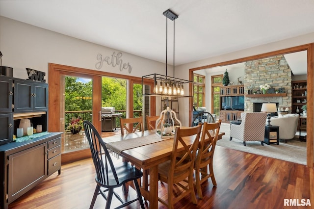 27998 229th St, Le Claire, IA 52753 - dining area featuring light wood-type flooring and a fireplace