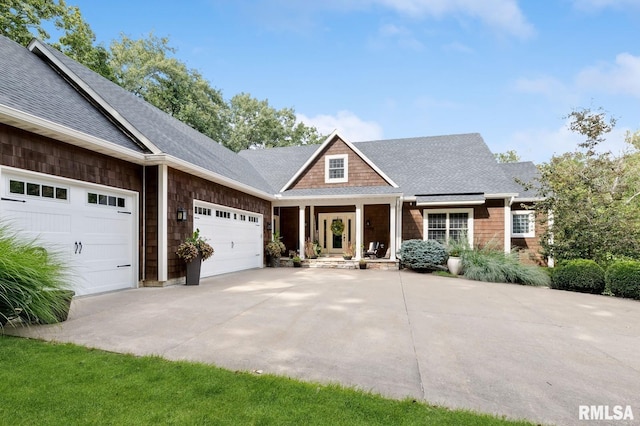 27998 229th St, Le Claire, IA 52753 - craftsman-style home featuring an attached garage, a shingled roof, and driveway