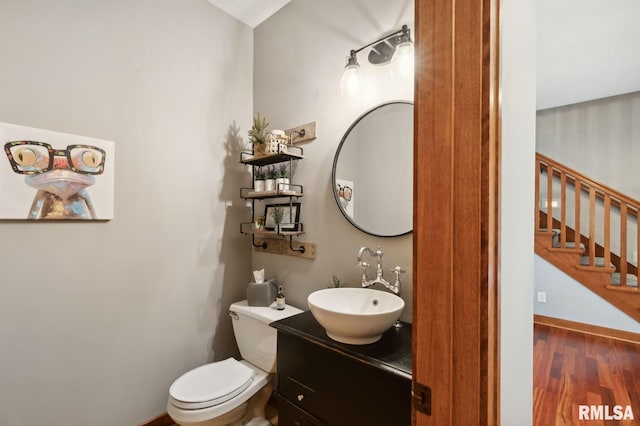 27998 229th St, Le Claire, IA 52753 - half bath with toilet, wood finished floors, and vanity