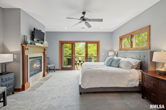 27998 229th St, Le Claire, IA 52753 - bedroom with access to outside, carpet floors, a tiled fireplace, recessed lighting, and a ceiling fan