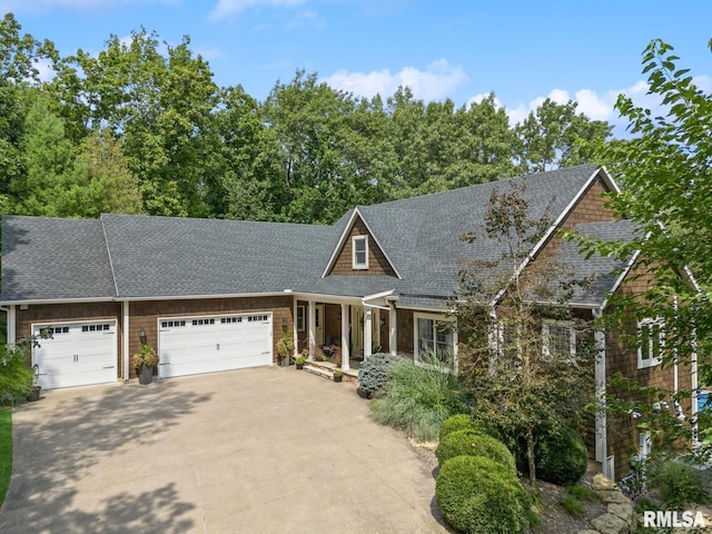 27998 229th St, Le Claire, IA 52753 - view of front of house with roof with shingles, a garage, concrete driveway, and a porch