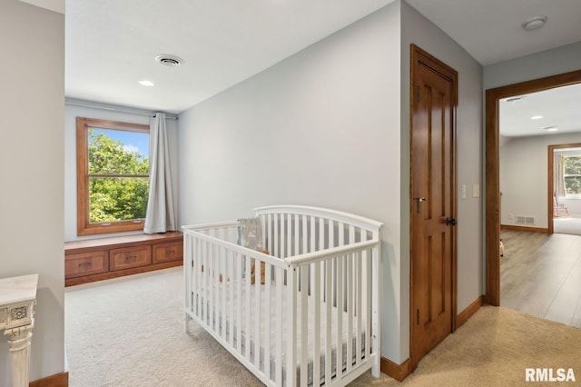 27998 229th St, Le Claire, IA 52753 - bedroom featuring light colored carpet, baseboards, and recessed lighting