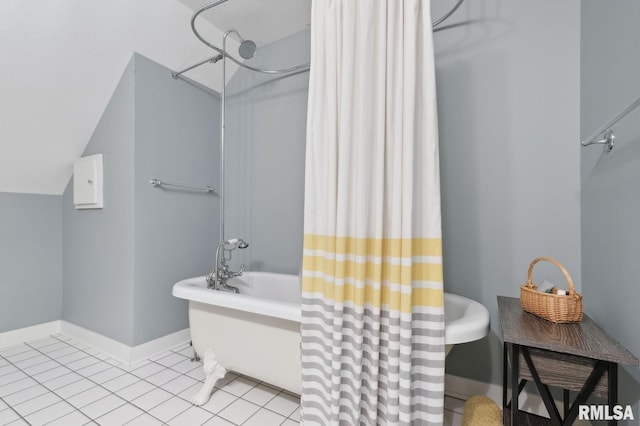 27998 229th St, Le Claire, IA 52753 - bathroom featuring baseboards, tile patterned floors, and vaulted ceiling
