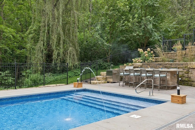 27998 229th St, Le Claire, IA 52753 - view of swimming pool with a patio area and a forest view
