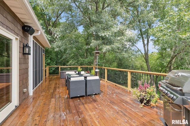 27998 229th St, Le Claire, IA 52753 - wooden terrace with grilling area, view of wooded area, and outdoor dining area