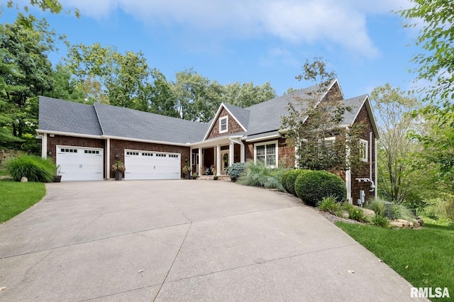 27998 229th St, Le Claire, IA 52753 - craftsman house with a garage, driveway, a front yard, and roof with shingles