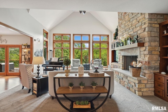 27998 229th St, Le Claire, IA 52753 - carpeted living area featuring a stone fireplace and high vaulted ceiling