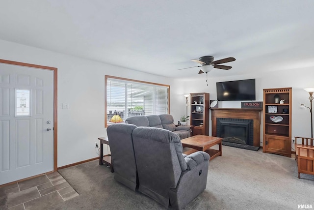 21704 283rd Ave, Le Claire, IA 52753 - carpeted living room with plenty of natural light, a fireplace, and a ceiling fan