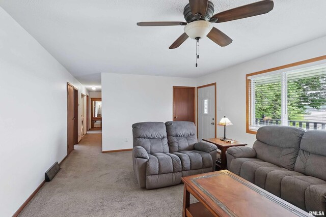 21704 283rd Ave, Le Claire, IA 52753 - living room featuring light carpet, a ceiling fan, and baseboards