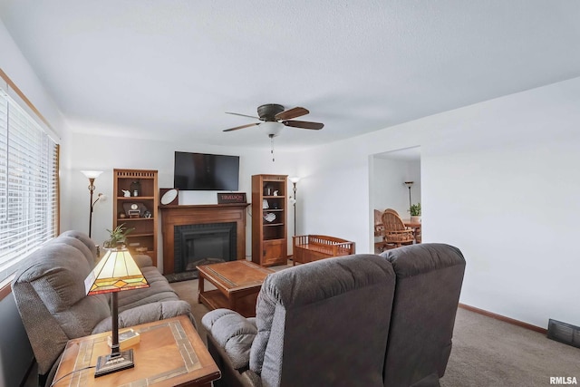 21704 283rd Ave, Le Claire, IA 52753 - carpeted living room with a ceiling fan, a fireplace, and baseboards