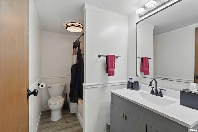 21704 283rd Ave, Le Claire, IA 52753 - full bathroom with toilet, vanity, a wainscoted wall, wood finished floors, and shower / tub combo with curtain