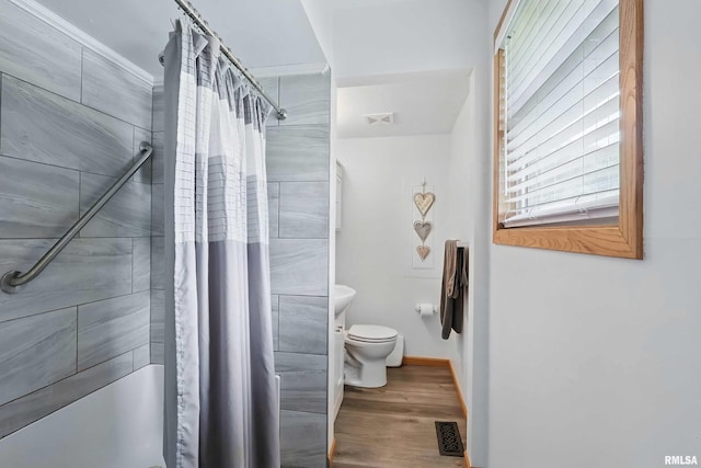 21704 283rd Ave, Le Claire, IA 52753 - full bathroom featuring toilet, a shower with curtain, wood finished floors, and baseboards
