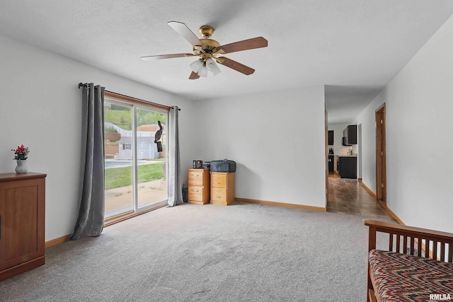 21704 283rd Ave, Le Claire, IA 52753 - carpeted empty room featuring ceiling fan, baseboards, and a textured ceiling