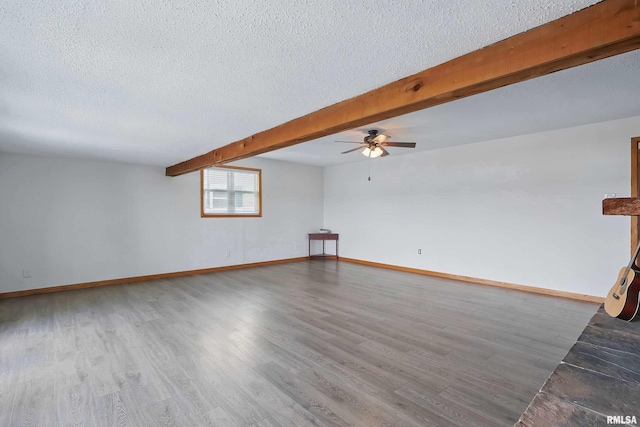 21704 283rd Ave, Le Claire, IA 52753 - unfurnished room featuring a textured ceiling, ceiling fan, wood finished floors, baseboards, and beamed ceiling