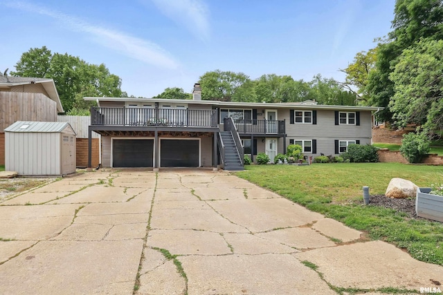 21704 283rd Ave, Le Claire, IA 52753 - view of front of house featuring an attached garage, a chimney, a wooden deck, concrete driveway, and stairs