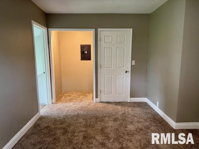 1203 13th Ave S, Clinton, IA 52732 - spare room with carpet floors, electric panel, and baseboards