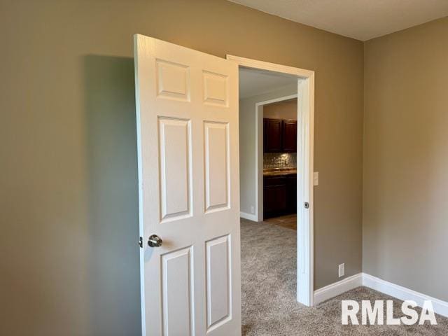 1203 13th Ave S, Clinton, IA 52732 - carpeted empty room with baseboards