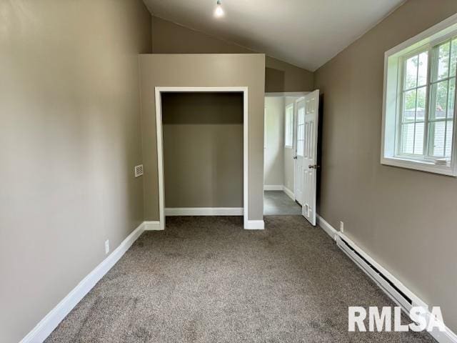 1203 13th Ave S, Clinton, IA 52732 - unfurnished bedroom with baseboard heating, lofted ceiling, carpet floors, baseboards, and a closet