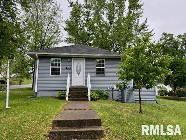 1203 13th Ave S, Clinton, IA 52732 - view of front of house with a front yard, a shingled roof, and entry steps