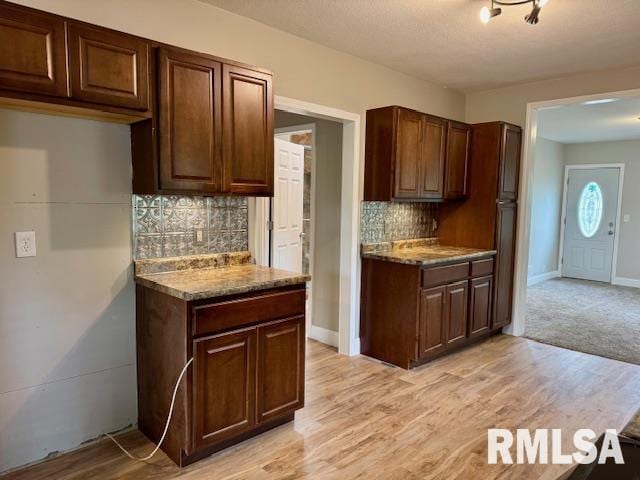1203 13th Ave S, Clinton, IA 52732 - kitchen featuring decorative backsplash, light wood finished floors, and baseboards