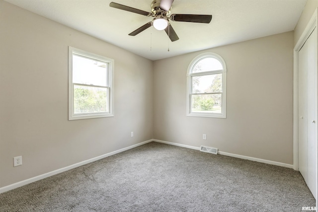 301 5th St, Matherville, IL 61263 - empty room featuring carpet flooring, a ceiling fan, and baseboards
