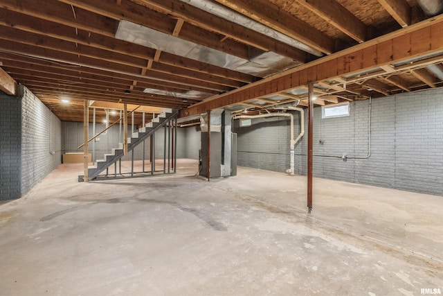 301 5th St, Matherville, IL 61263 - unfinished basement with heating unit, stairway, and brick wall