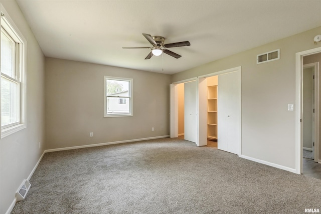 301 5th St, Matherville, IL 61263 - unfurnished bedroom featuring carpet, baseboards, a spacious closet, and a ceiling fan