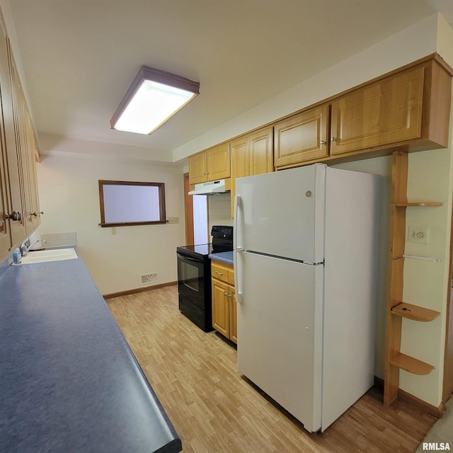 2727 32nd Avenue Ct, Rock Island, IL 61201 - kitchen with black / electric stove, freestanding refrigerator, under cabinet range hood, a sink, and light wood-style floors