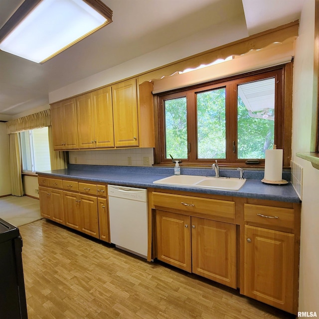 2727 32nd Avenue Ct, Rock Island, IL 61201 - kitchen with white dishwasher, a sink, black electric range oven, dark countertops, and plenty of natural light