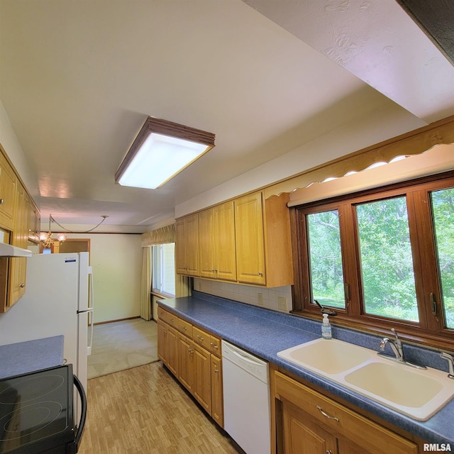 2727 32nd Avenue Ct, Rock Island, IL 61201 - kitchen with white dishwasher, a sink, light wood finished floors, and plenty of natural light