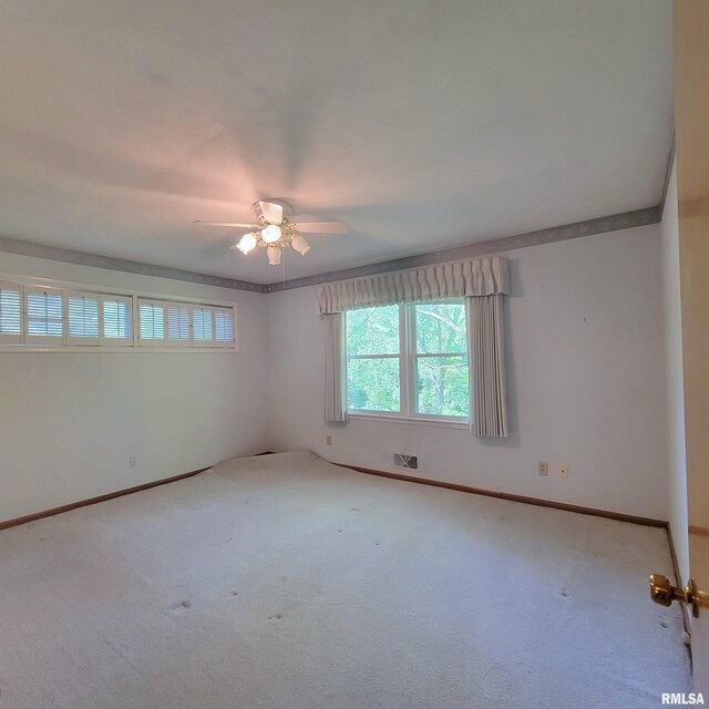 2727 32nd Avenue Ct, Rock Island, IL 61201 - empty room with a ceiling fan, carpet floors, and baseboards