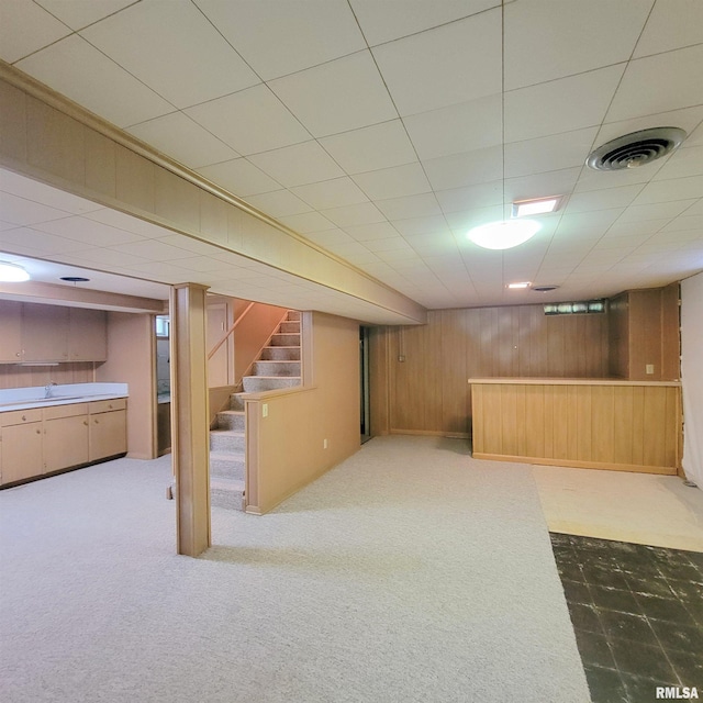 2727 32nd Avenue Ct, Rock Island, IL 61201 - finished below grade area with stairway, wood walls, carpet, and a sink