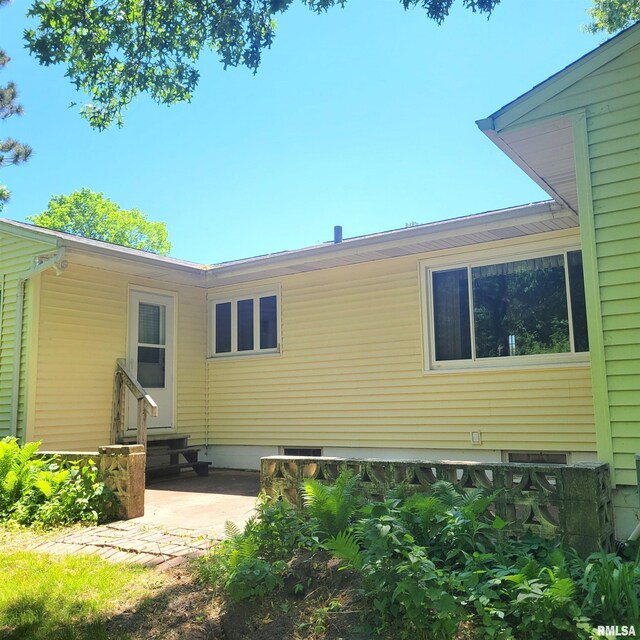 2727 32nd Avenue Ct, Rock Island, IL 61201 - rear view of property with entry steps and a patio
