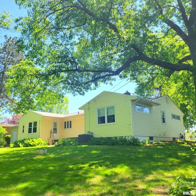 2727 32nd Avenue Ct, Rock Island, IL 61201 - back of property featuring a lawn and central AC unit