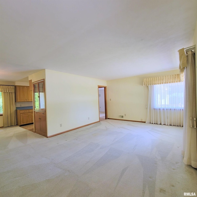 2727 32nd Avenue Ct, Rock Island, IL 61201 - unfurnished living room featuring baseboards and light colored carpet