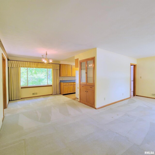 2727 32nd Avenue Ct, Rock Island, IL 61201 - unfurnished living room with a chandelier, light carpet, and baseboards
